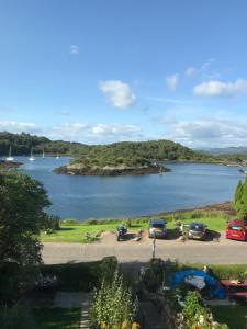 a view of a large body of water with cars parked at The Moorings in Tarbert