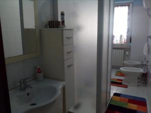 a bathroom with a sink and two toilets at Appartamento IL PORTO in Martinsicuro