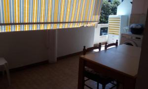 a kitchen with a wooden table and a window at Appartamento IL PORTO in Martinsicuro