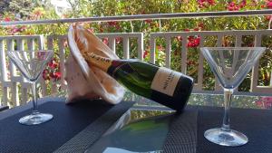 a bottle of wine sitting on a table with two glasses at Marion apartment in Portorož