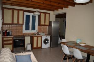 a kitchen with a table and a dining room at Monolithos Villas in Kipri