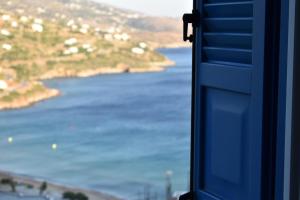 a view of the ocean from a window at Monolithos Villas in Kipri