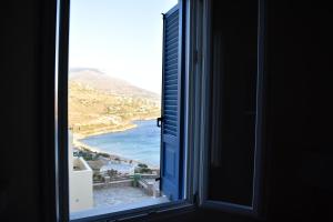 an open window with a view of the ocean at Monolithos Villas in Kipri