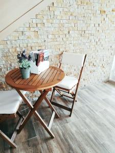a wooden table with a chair and books on it at Pod hradem Cornštejn in Oslnovice