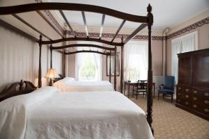 a bedroom with two beds and a table and chairs at Middlebury Inn in Middlebury +81 photos