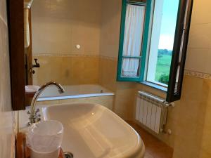 a bath tub in a bathroom with a window at Casa da Roxa in Foz
