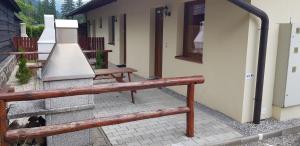 a group of benches sitting outside of a building at Apartments Michalka - ap. dom Skalka in Donovaly