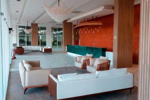 a lobby with couches and chairs in a building at SALINAS PARK RESORT in Salinópolis