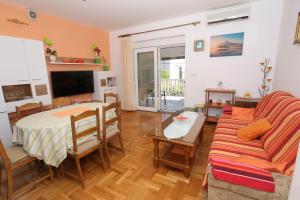 a living room with a couch and a table at Apartman Luna in Dugi Rat