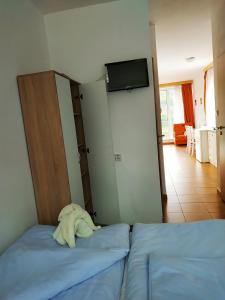 a bedroom with two beds and a tv on the wall at Pod hradem Cornštejn in Oslnovice