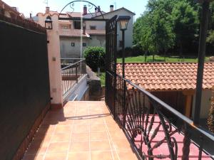 a balcony with a black fence and a house at APARTAMENTOS LA CASONA DE EZCARAY CON TERRAZAS y PATIOS INDIVIDUALES in Ezcaray