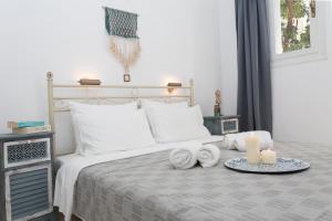 a bed with two towels and two candles on it at Galini Mare in Agia Galini