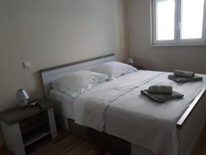 a bedroom with a bed with two towels on it at Apartments Juliet in Orebić