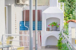 a balcony with blue tiles and a plant at Skalla Studios in Limenas