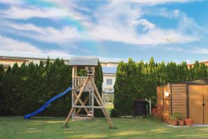 a playground with a slide and a swing set at Schöne Zeit in Friedrichshafen
