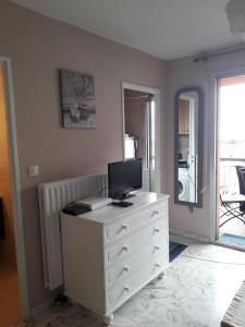 a white dresser with a computer on top of it at Studio Californie in Nice