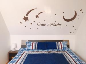 a bedroom with a bed with a crescent moon and stars at Schöne Zeit 2 rooms apartment with kitchen in Friedrichshafen