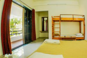 a bedroom with two bunk beds and a window at Rainwood Residency in Lonavala