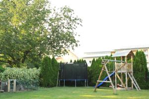 a playground in a yard with a slide at Schöne Zeit in Friedrichshafen +7 photos
