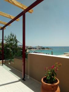 a terrace with a potted plant and a view of the ocean at Markella's Paradise in Kavála