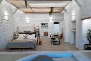 a bedroom with a large bed and a table at Aphrodite Luxury apartment in Astypalaia Town