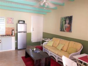 a living room with a couch and a table at SXM Spotters Paradise in Lowlands