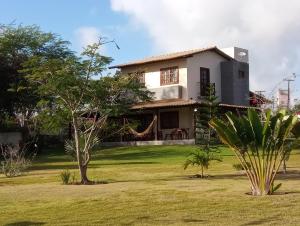 a house with a playground in front of it at Casa Rústica em Gravatá in Gravatá