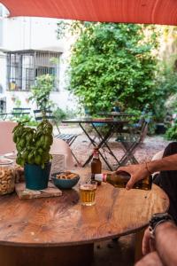 Ein Mann, der eine Flasche Wein auf einen Tisch gießt. in der Unterkunft Borgo Vergini Garden B&B in Neapel