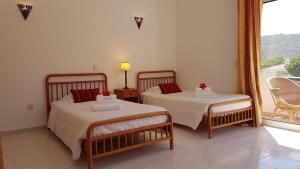 Villa Navita tesisinde bir odada yatak veya yataklar