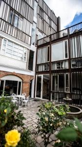 a patio in front of a building with two chairs at Illa Experience Hotel in Quito