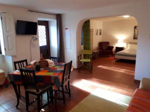 a living room with a table and chairs and a bedroom at Quintinha de Santiago in Oliveira de Azemeis +41 photos