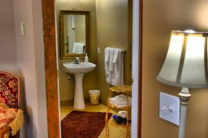 a bathroom with a sink and a mirror at Bard's Inn in Cedar City