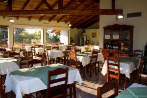 a restaurant with tables and chairs with white table cloth at HOTEL MIRAMAR in Miramar