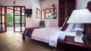 Кровать или кровати в номере Hotel El Pequeño Gecko Verde