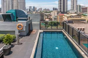 a balcony with a swimming pool on top of a building at Amelie Hotel Manila in Manila