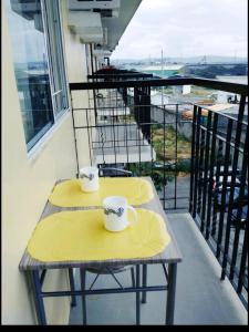 two coffee cups on a table on a balcony at The Escape Pad 1 by Sharon May in Manila