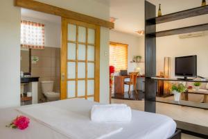 a bedroom with a bed and a living room at Vanilla Sky Dive Resort in Panglao Island