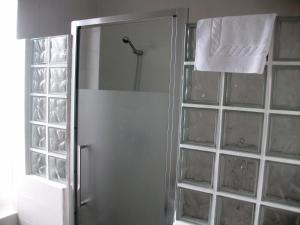 a bathroom with a shower with a glass door at Hotel Neguri in Getxo