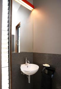 a bathroom with a sink and a mirror at Riversdale Retreat in Chewton
