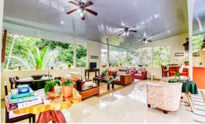 a living room filled with furniture and a large window at San Rafael Ecolodge in San Gerardo