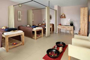 a living room with a couch and a mirror at Swiss-Belresort Pecatu in Uluwatu +24 photos