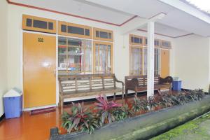 a building with benches and plants in front of it at Hotel Wijaya 2 Kaliurang in Yogyakarta