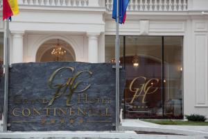 a sign in front of a grand hotel continental at Grand Hotel Continental in Bucharest