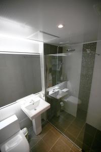 Un baño con lavabo, inodoro y ducha. en Moon Sun Guesthouse, en Seúl