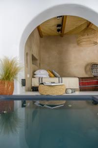 a room with a bed and a pool of water at Euphoria Chora Naxos in Naxos Chora