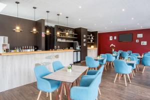 a restaurant with blue chairs and a bar at Best Western Plus Antibes Riviera in Antibes
