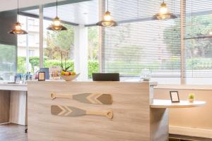 a kitchen with a wooden counter with a counter top at Best Western Plus Antibes Riviera in Antibes