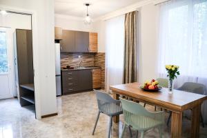 a kitchen and dining room with a wooden table and chairs at Garden Inn Resort Sevan in Sevan +58 photos