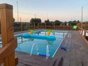 a pool with two inflatables in the water at U’ Fore B&B Relax garden in Noci