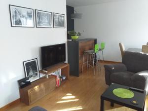 a living room with a couch and a television at Sanjar in Vrnjačka Banja